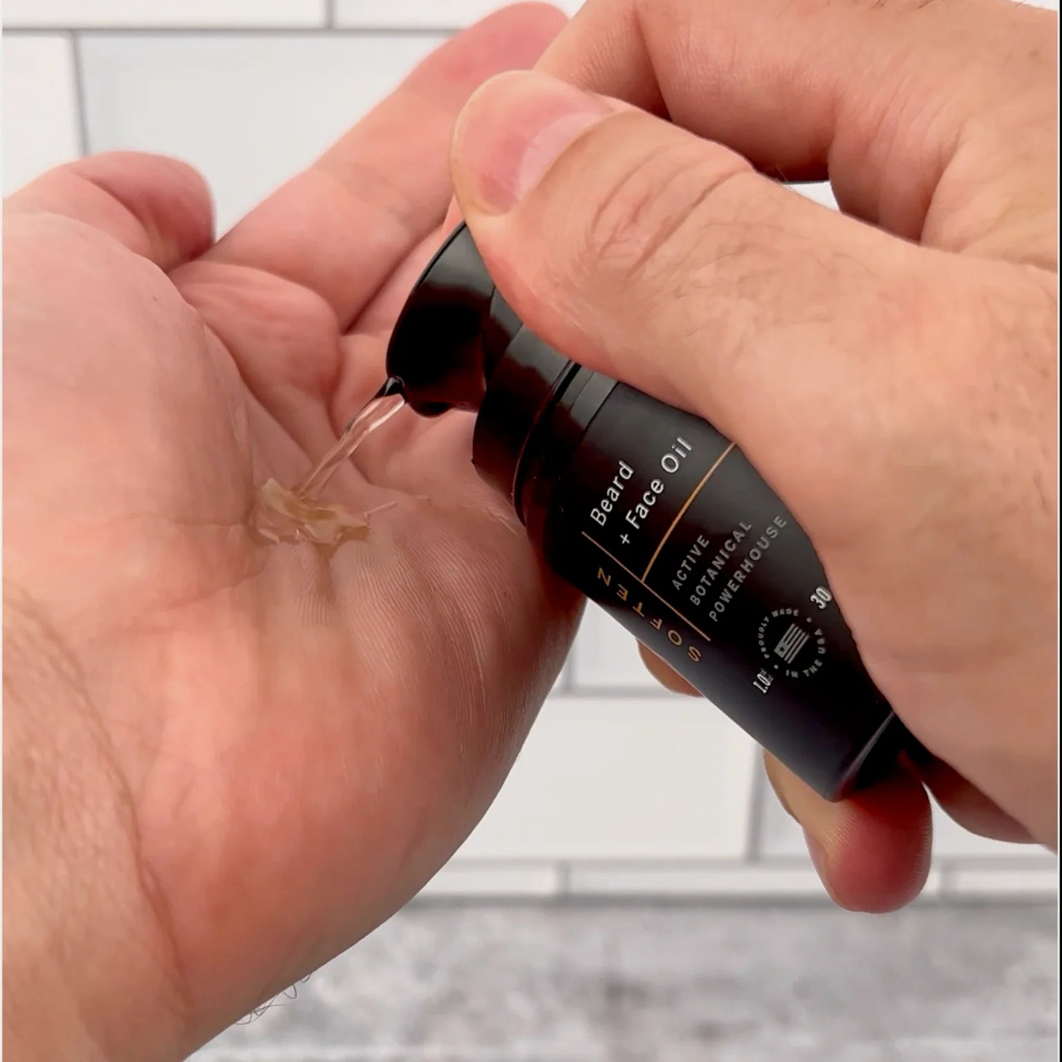 Dispensing Stubble & Stache Soften daily beard + face oil into hand, Step 3 of the Face + Beard Care System.