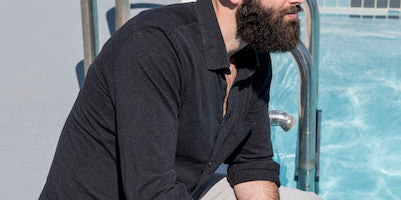 man with beard sitting by the pool. Do beards make you warmer?