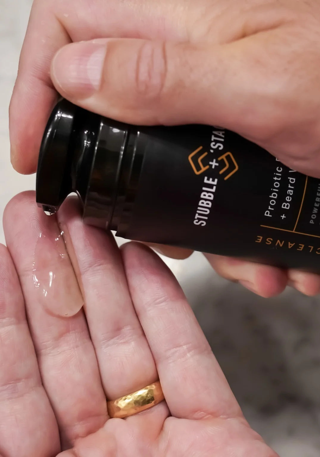 Stubble & Stache Cleanse face and beard wash with airless pump dispensing into hand