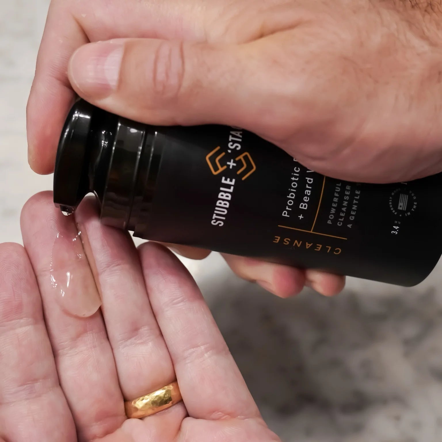 Dispensing Stubble & Stache Cleanse face + beard wash into hand, Step 1 of the Face + Beard Care System