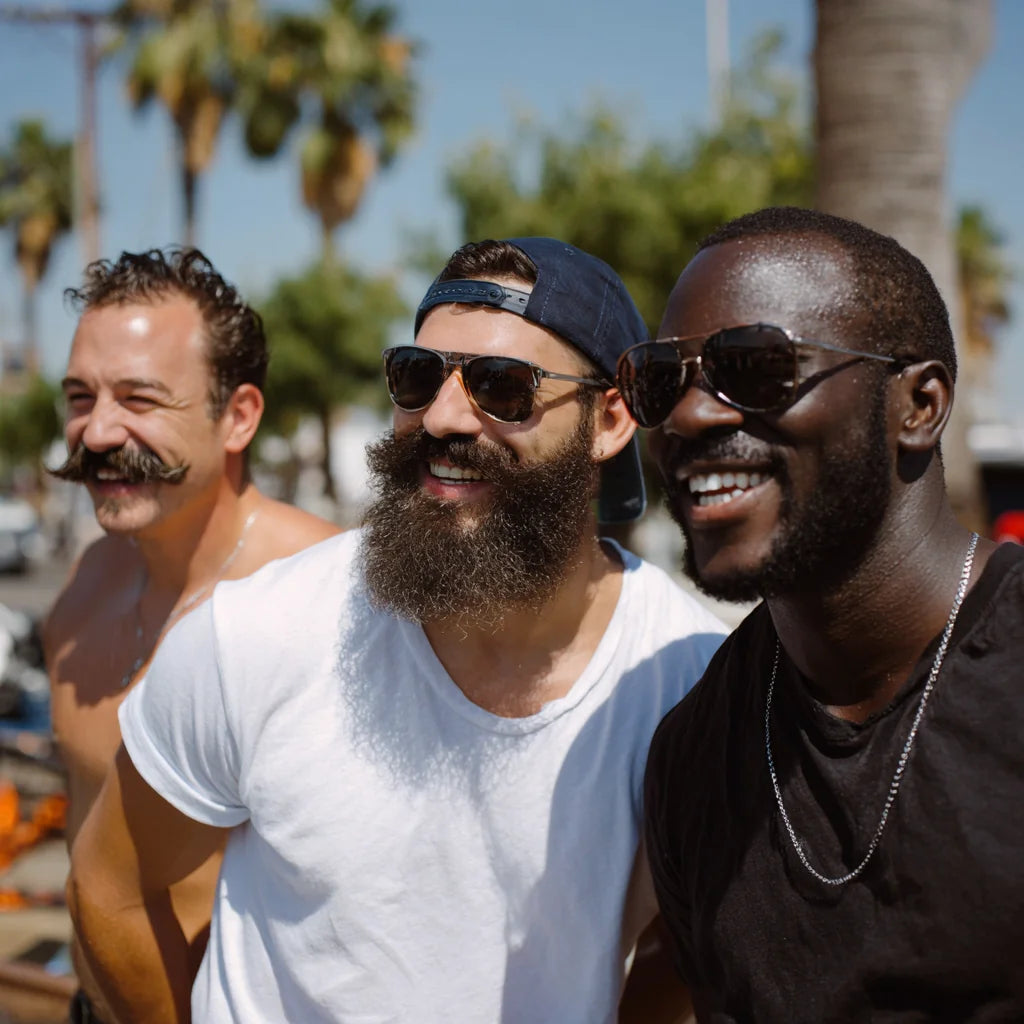Three men with different facial hair styles — stubble, beard, and mustache — representing Stubble & Stache skincare made for all types of facial hair