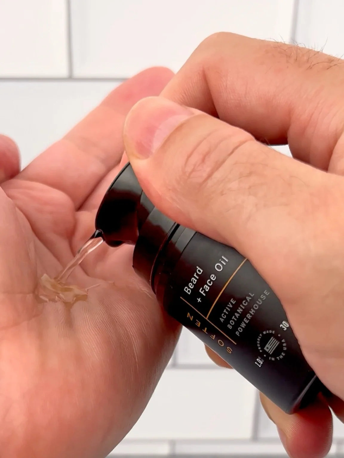 Close-up of Stubble & Stache Soften Beard + Face Oil being dispensed into hand, mobile format