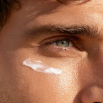 Man’s eye with Refresh Eye Cream applied under-eye area, mobile close-up view