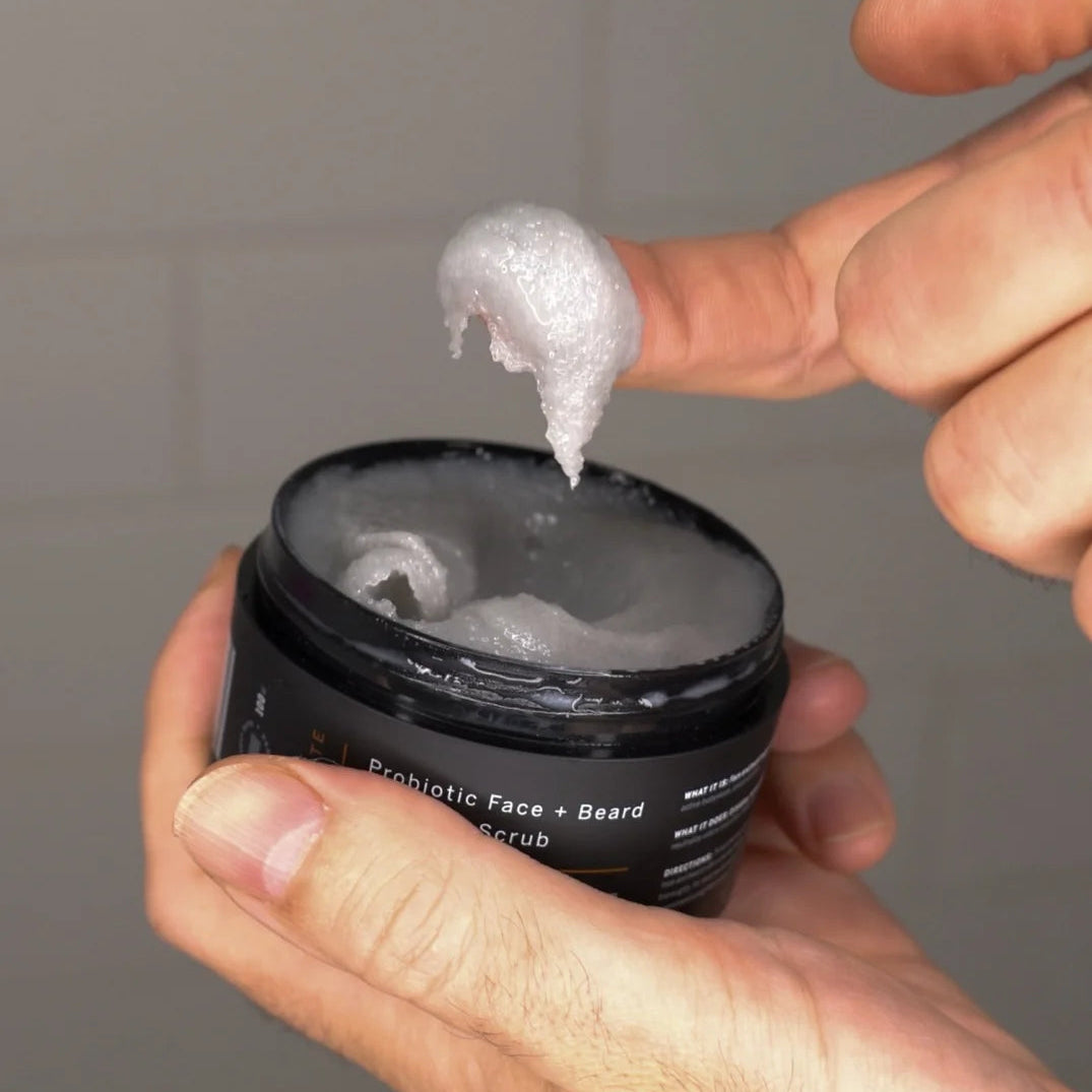 Man scooping Stubble & Stache Exfoliate Probiotic Face + Beard Scrub with finger, showing texture and consistency