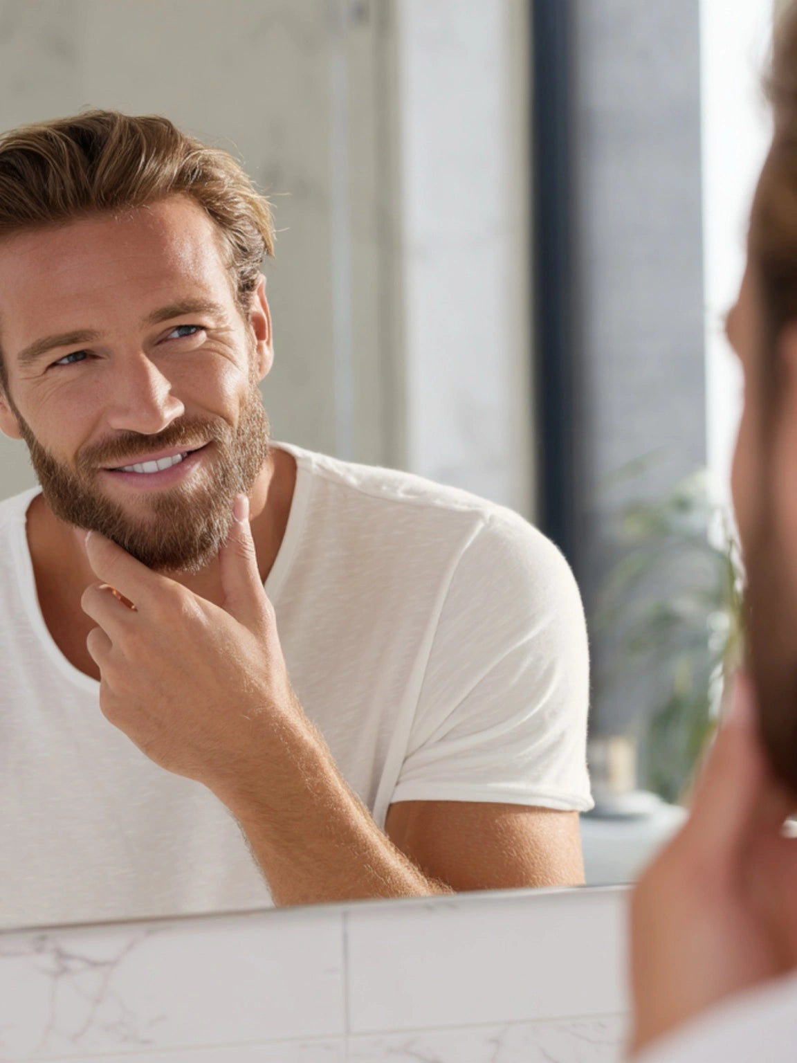 Man with beard smiling in the mirror after applying Stubble & Stache Groom Beard Balm — mobile banner.