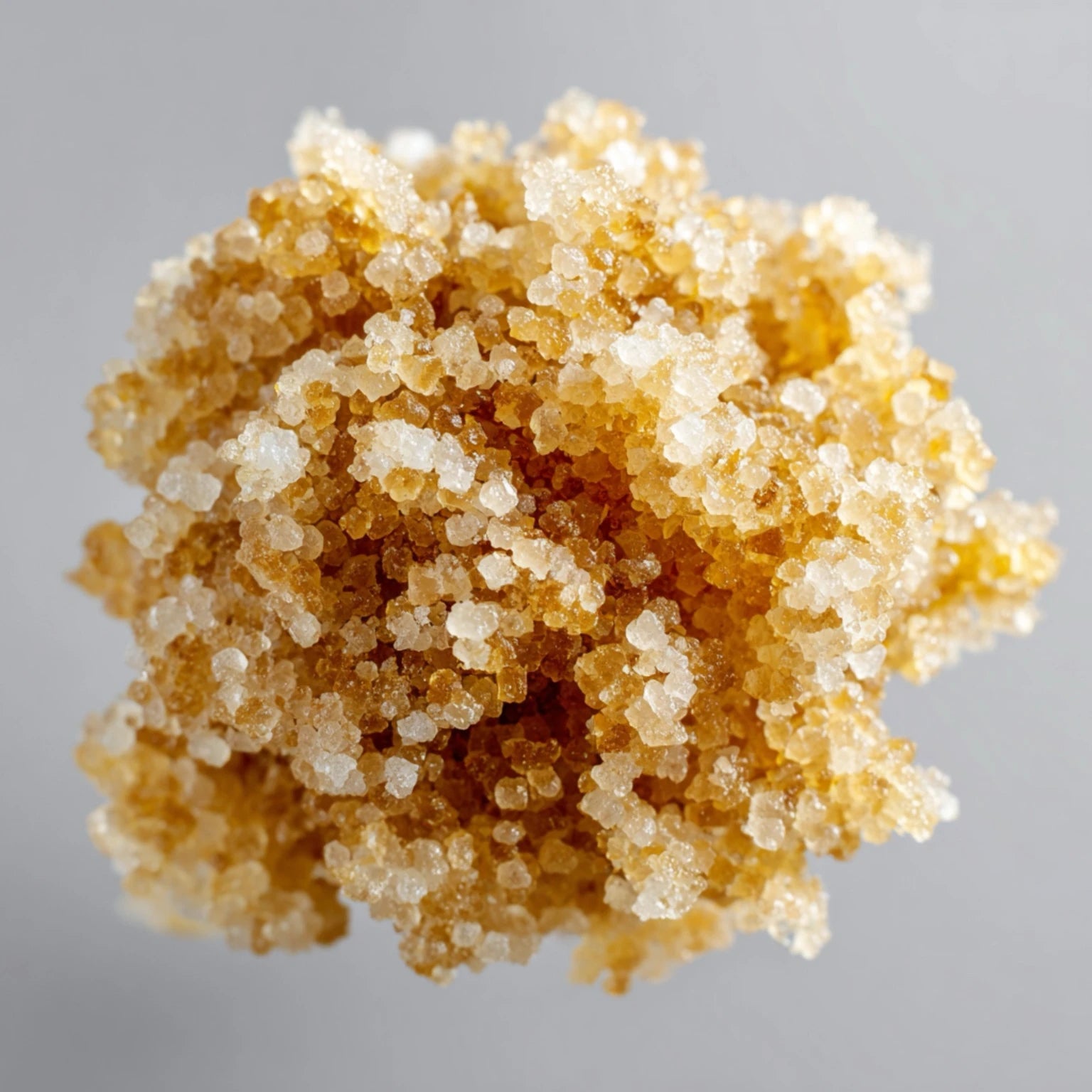 Close-up of golden sugar crystals, a gentle beard-safe exfoliant that melts cleanly without snagging facial hair